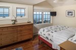 Master bedroom with a queen bed and beautiful ocean views.